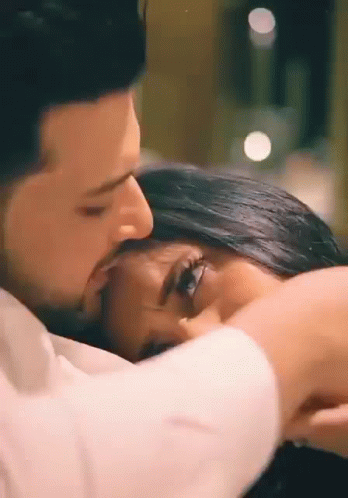 Man Kissing Woman On Forehead In Bed GIF