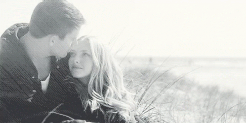 Man Kissing Woman On Forehead On Beach GIF