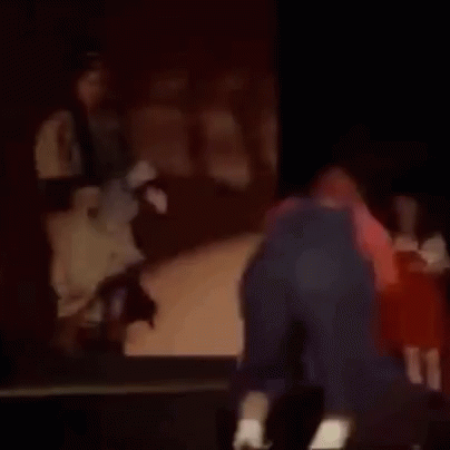 Man Kneeling at Piano with Woman Behind