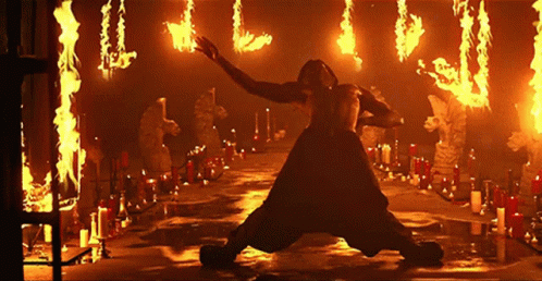 Man Kneeling Before Flames and Candles