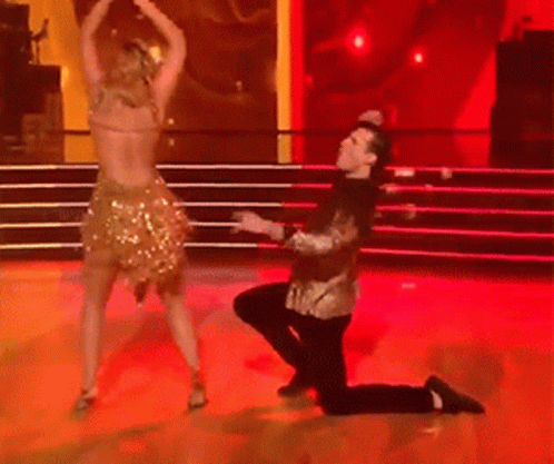 Man Kneeling Before Woman Dancing