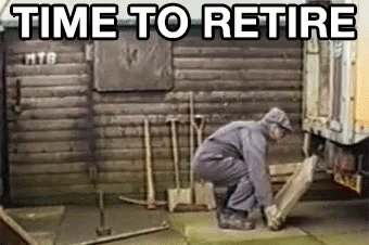 Man Kneeling Before Wooden Building Time To Retire