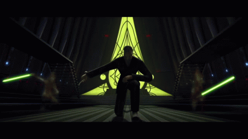 Man Kneeling Before Yellow Triangle