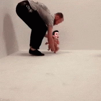 Man Kneeling Beside Baby With Man's Face Picture