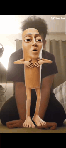 Man Kneeling Beside Cartoon Sausage Stick