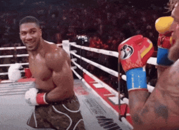 Man Kneeling in Boxing Ring Smiling