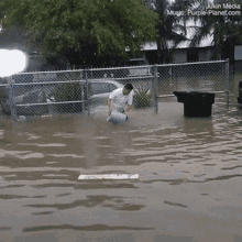 Man Kneeling In Flooded Area GIF