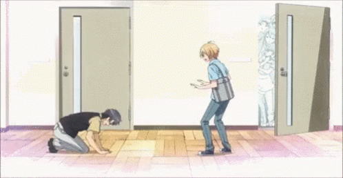 Man Kneeling in Front of Door With Another Man Standing