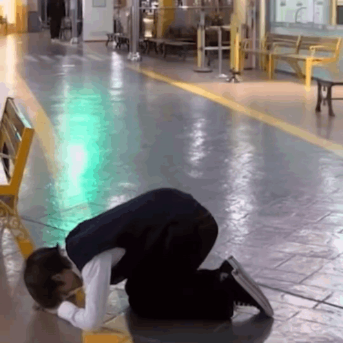 Man Kneeling in Hallway