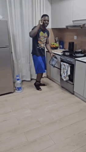 Man Kneeling in Kitchen with Aquafina Water