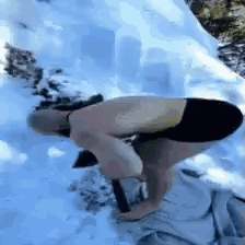Man Kneeling in Snow with Shovel