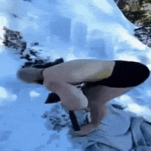 Man Kneeling in Snow Without Shirt