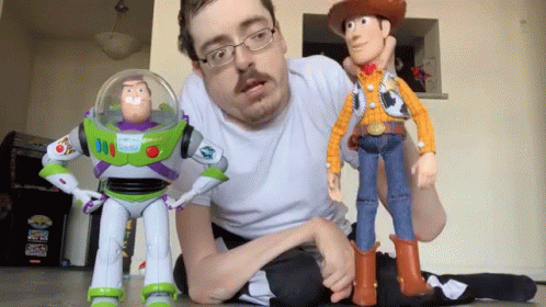 Man Kneeling Next to Toy Story Buzz Lightyear and Woody