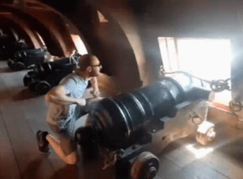 Man Kneeling On Cannon GIF