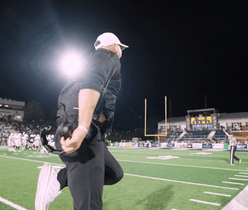 Man Kneeling on Football Field Saying Texas