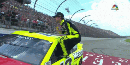 Man Kneeling On Hood Of Race Car Saying Blaney GIF