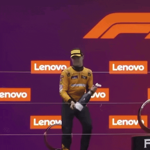 Man Kneeling On Podium With Lenovo Sign GIF