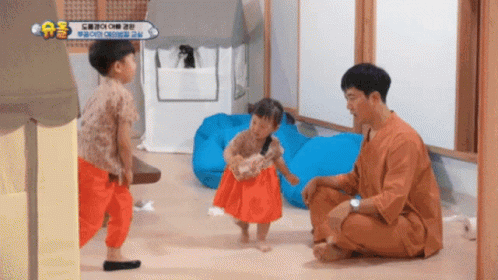 Man Kneeling With Two Little Girls and AE Sign