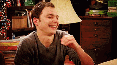 Man Laughing at Table With Lamp