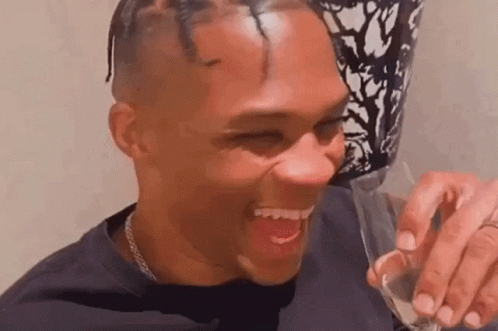 Man Laughing Holding Glass Of Wine GIF