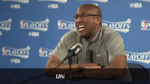 Man Laughing in Front of NBA Playoffs Sign