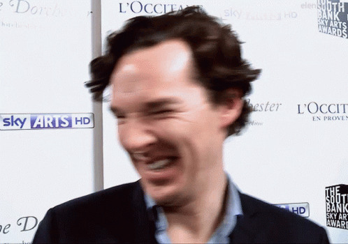Man Laughing In Front Of Sky Arts HD Sign GIF