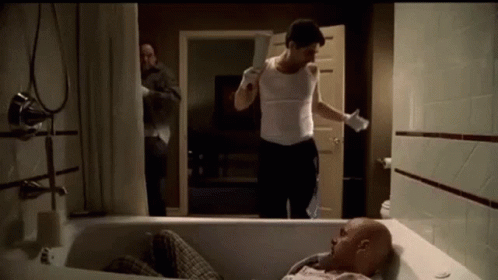 Man Laying in Bathtub Holding Knife