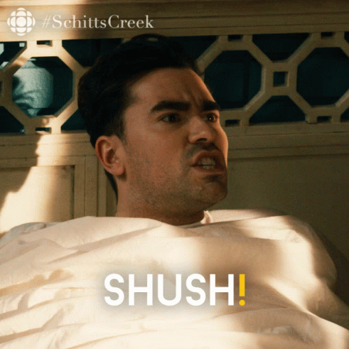 Man Laying In Bed Saying Shush GIF