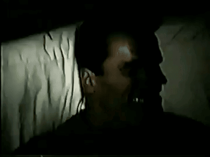 Man Laying in Dark Room With Mouth Open and Shadow