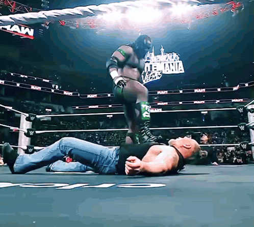 Man Laying in Wrestling Ring Raw Sign