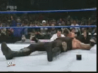 Man Laying In Wrestling Ring With Fox Logo GIF