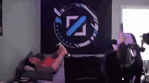 Man Laying on Bed in Front of Wall With Z Logo