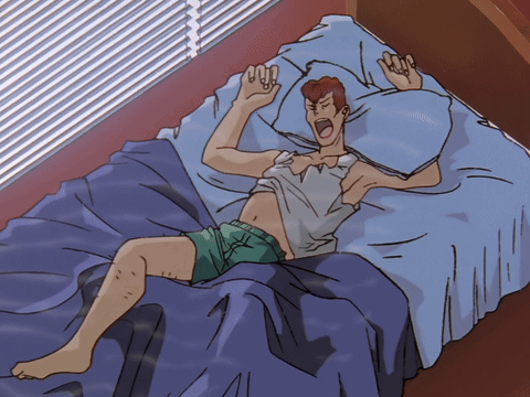 Man Laying on Bed With Pillow Over Head