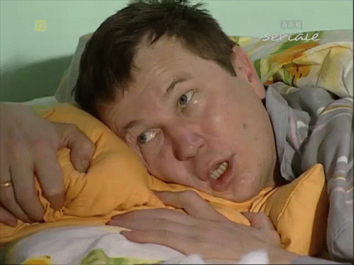 Man Laying On Bed With Seriale GIF