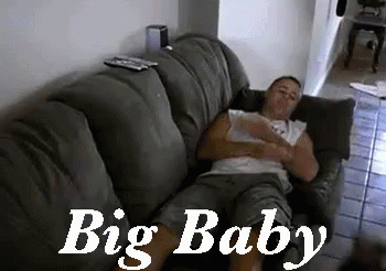 Man Laying on Couch Saying Big Baby