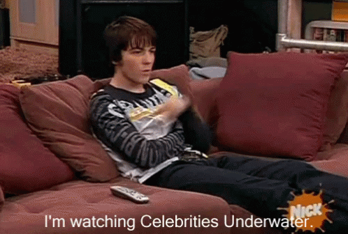 Man Laying on Couch Watching Celebrities Underwater