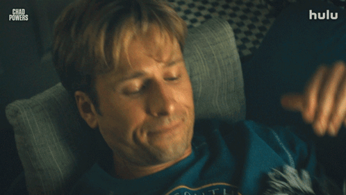 Man Laying on Couch With Hands Behind Head Chad Powers