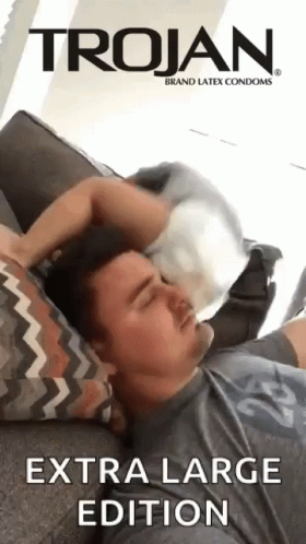 Man Laying on Couch with Trojan Condom on Head