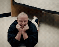 Man Laying on Floor Hands on Face