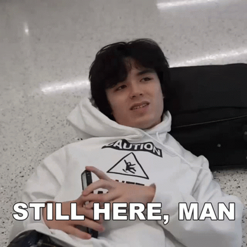 Man Laying On Floor In White Caution Hoodie GIF