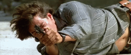 Man Laying on Ground Holding Gun
