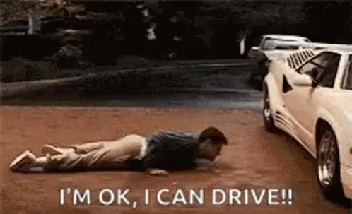 Man Laying on Ground Next to a Car