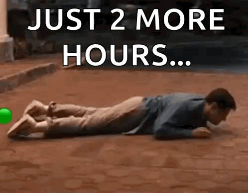 Man Laying On Ground Saying Just 2 More Hours GIF