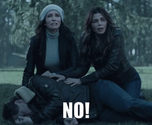 Man Laying on Ground With Two Women Screaming No