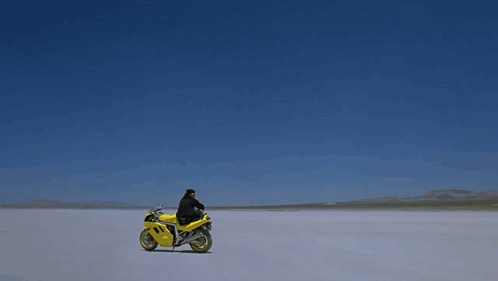 Man Laying on Yellow Motorcycle Number 1
