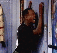 Man Leaning Against Door With Arms Up