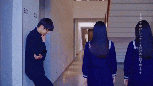 Man Leaning Against Wall In Hallway GIF