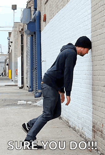Man Leaning Against Wall Saying Sure You Do