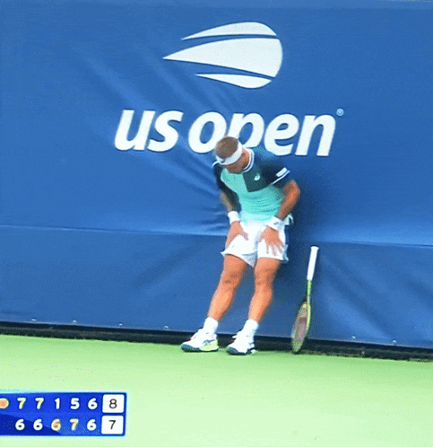 Man Leaning Against Wall With Tennis Racquet GIF