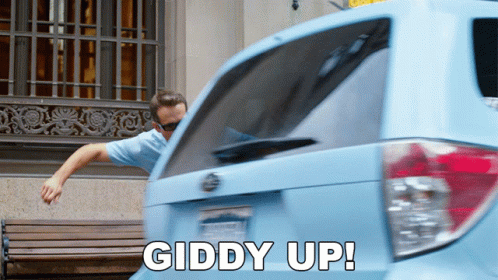 Man Leaning on Blue Car With Giddy Up